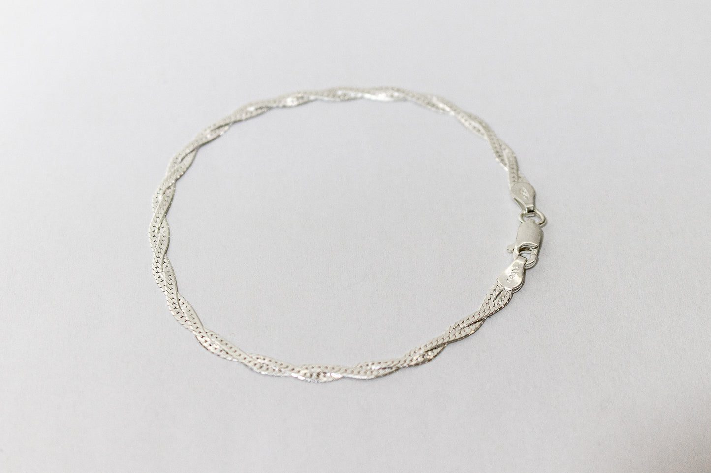 PULSEIRA TRANÇADA LAMINADA EM PRATA 925